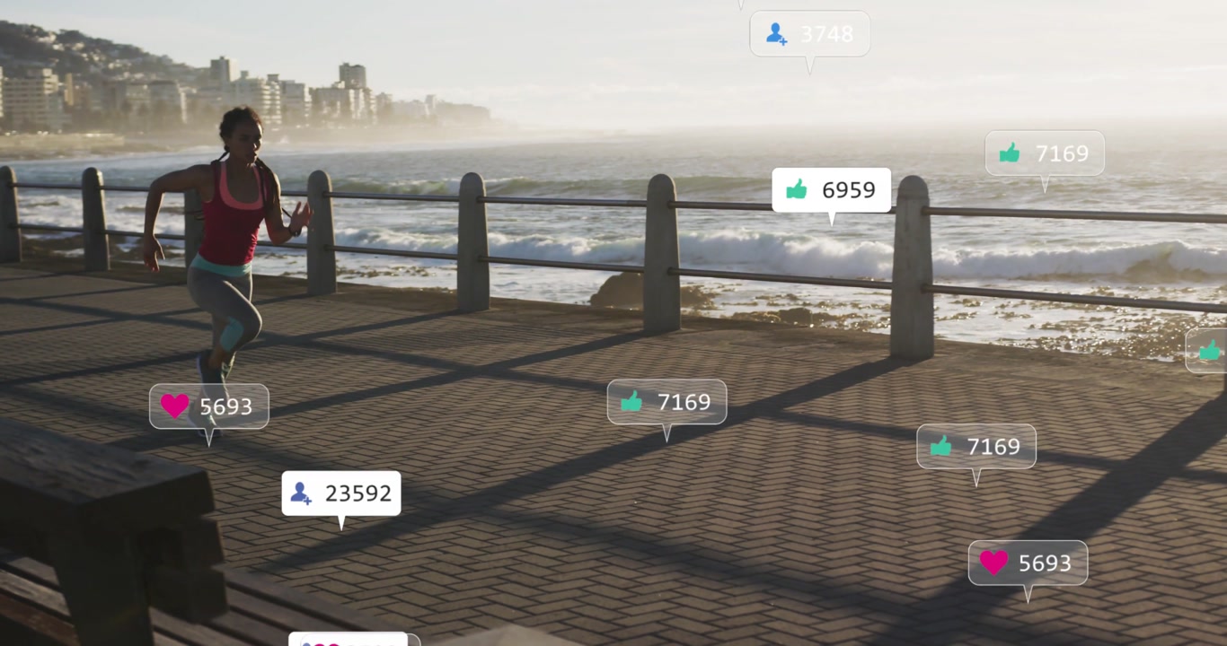 Female runner entering frame, jogging seafront, drawing social likes icons for fitness marketing