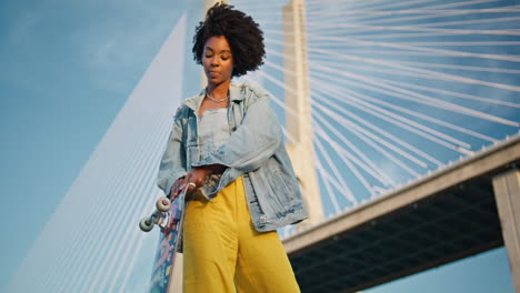 young woman skateboarding on a bridge