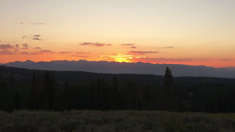 mountain peaks with glowing golden evening light at sunset in summertime
