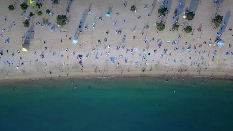 a moving aerial view of visitors at repulse bay beach in hong kong as public beaches reopening, after months of closure amid coronavirus outbreak, to the public