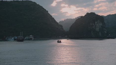 Aerial-view-of-boat-sailing-on-Lan-Ha-bay-during-sunset-in-Vietnam