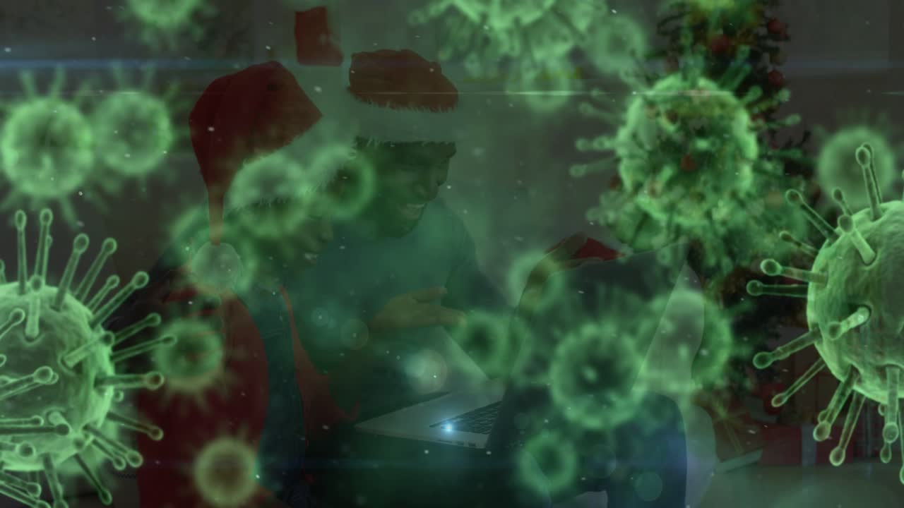 Dad tapping laptop to celebrate and kid watching green orbs shifting revealing holiday tree health