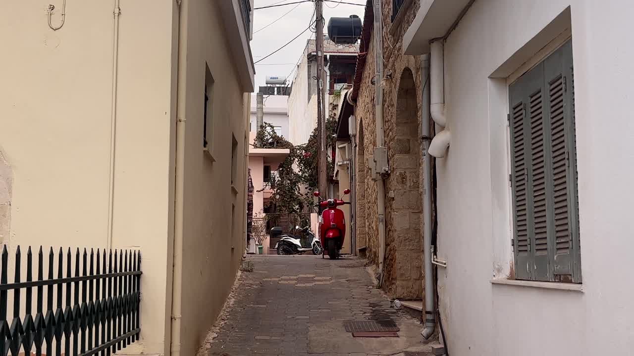 Narrow street in Chersonissos old town with bikes in view