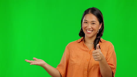 Happy-asian-woman,-hands-and-thumbs-up-on-green