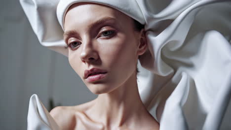 avant-garde fashion portrait in sculptural white garment
