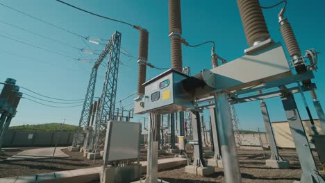 high voltage electrical substation under clear blue sky