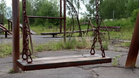 abandoned playground with rusty swing set