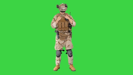 military soldier in uniform salutes on a green screen, chroma key