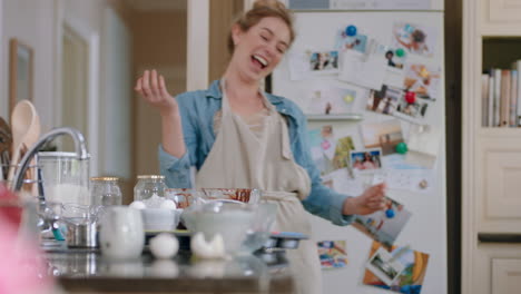 mother playing with little boy in kitchen having fun baking at home on weekend