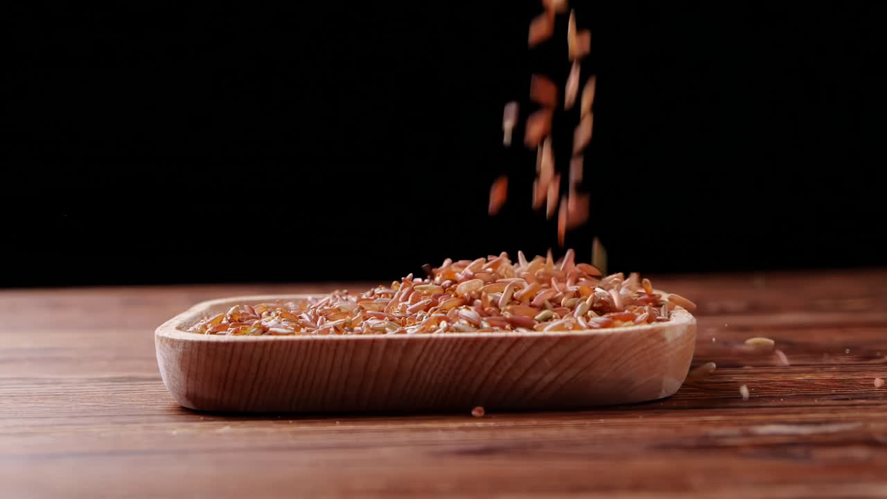 A variety of different colored Raw healthy grain food, Various grains, cereals, beans, legumes are rotated in wooden decoration for advertisement concept