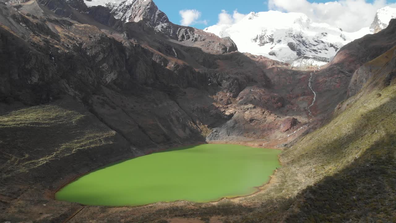 Amazing green lake in the peruvian andes, river from the glacier mountain, effects of meltdown, global warming.
