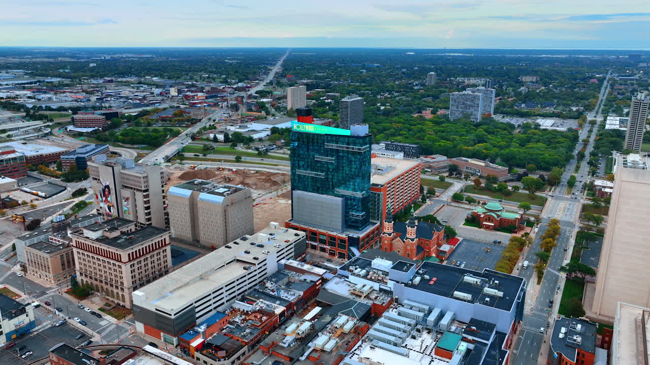 Detroit, USA, 28 July 2025: Approaching the glass building of the Hollywood Casino at Greektown in Detroit, Michigan, USA. Footage over the city on gloomy day