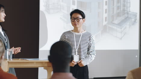 asian female speaker giving presentation on architecture conference