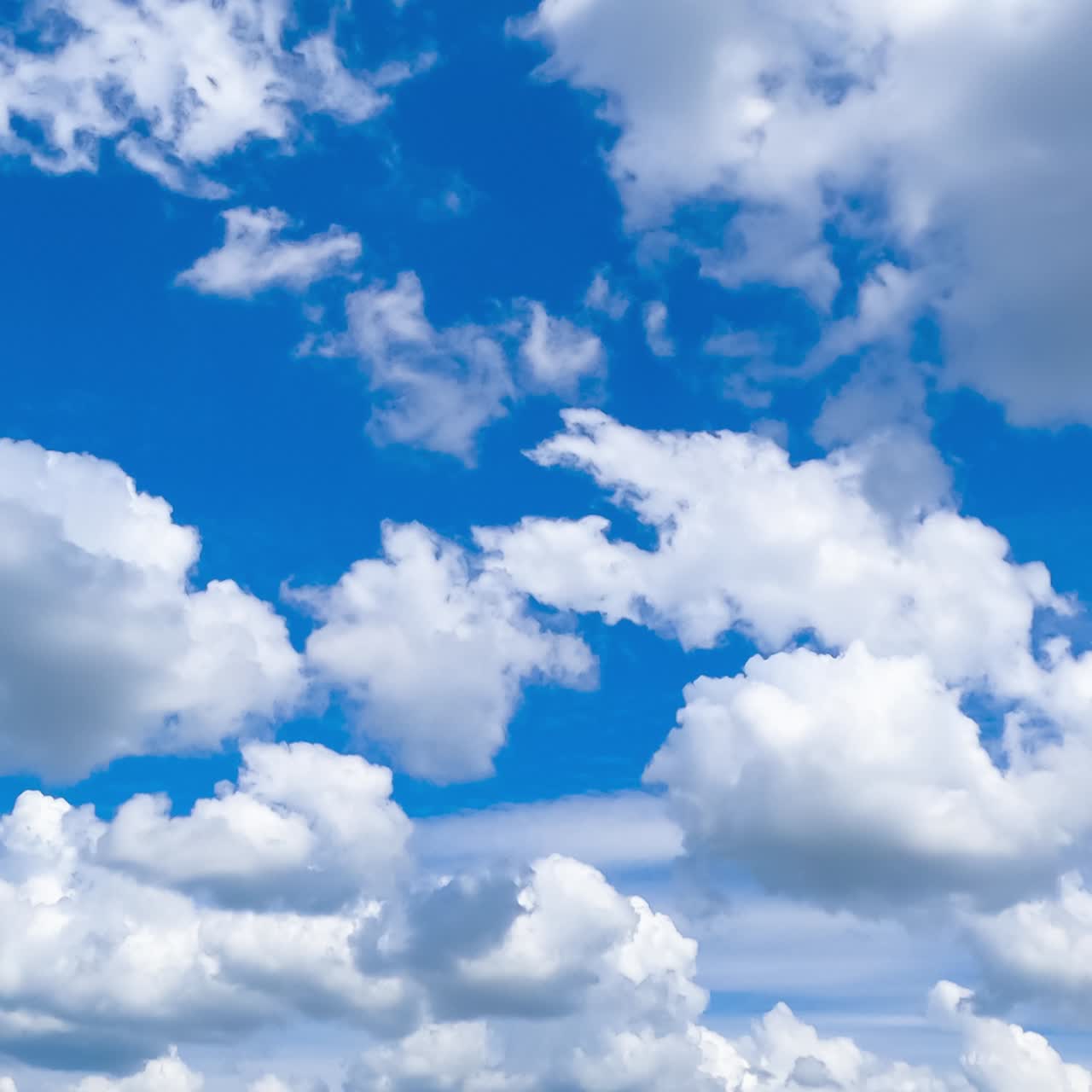 Different types of clouds moving in the bright horizon. Amazing heavenly cloudscape in the turquoise sky. Timelapse