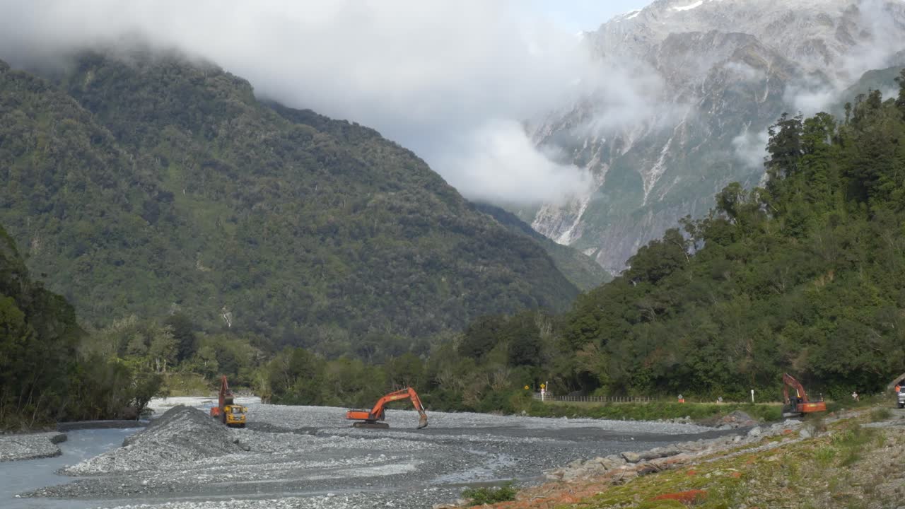 Excavators Working - Construction Site Near River In South Island, New Zealand - Wide Shot