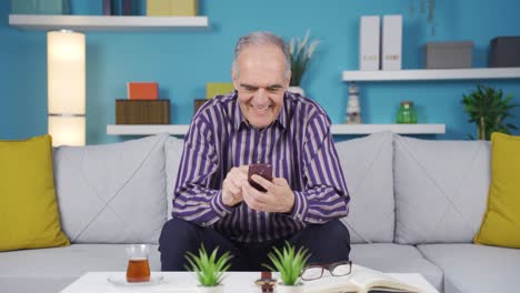 Happy-and-cute-old-man-texting-on-the-phone.