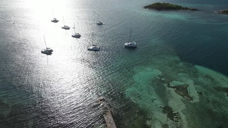 Descending-aerial-to-large-yachts-in-Jost-Van-Dyke-shallow-harbor-near-Foxy's-Taboo