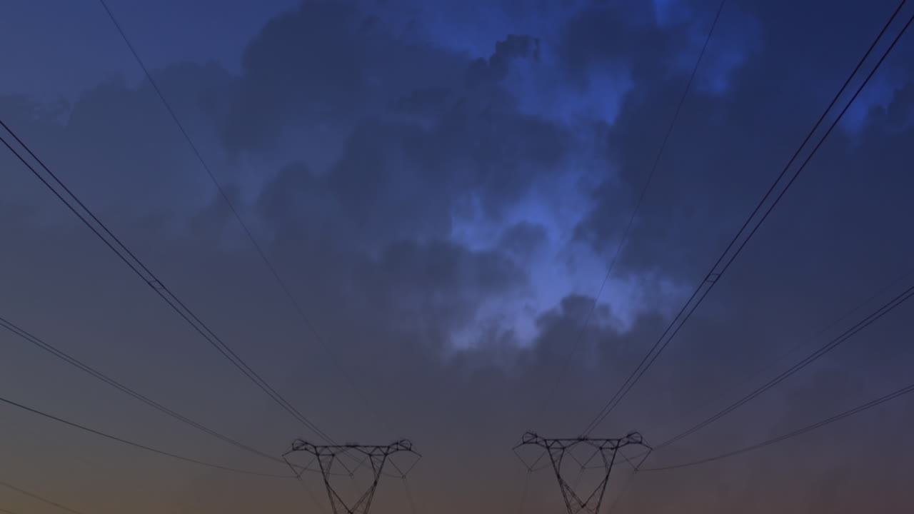Transmission towers and clouds