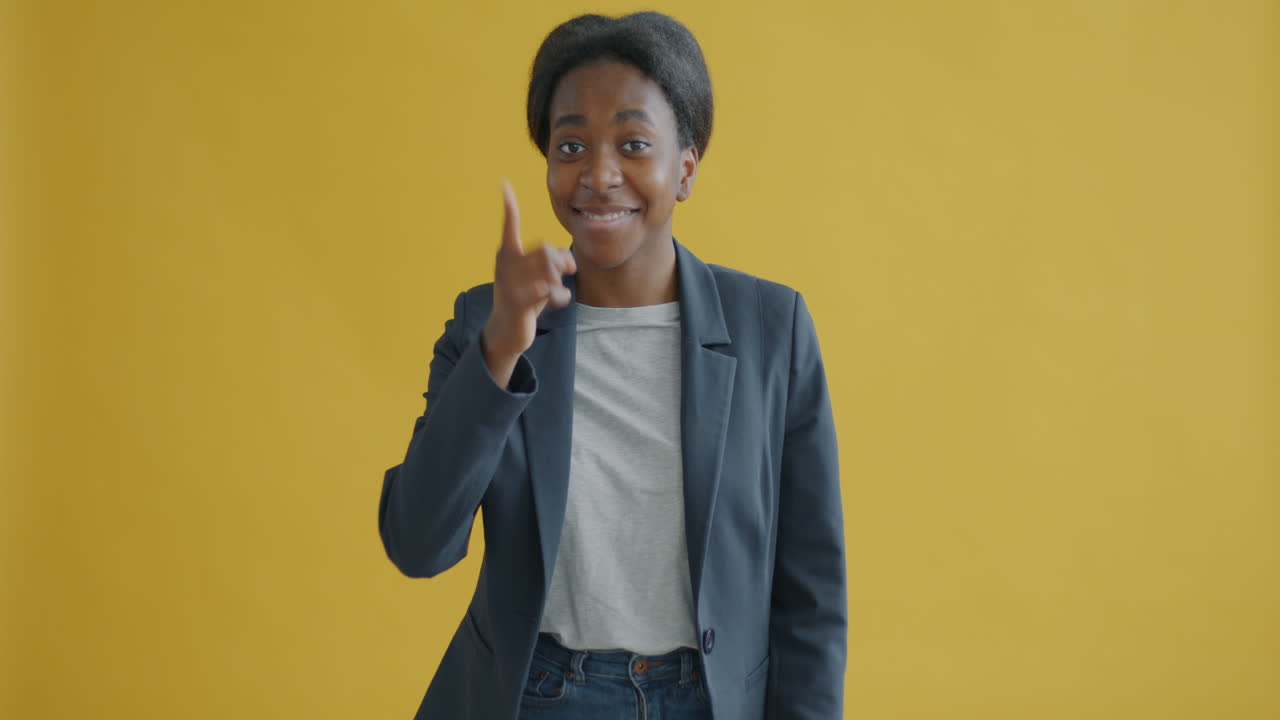 Young Woman Posing in Front of Yellow Background