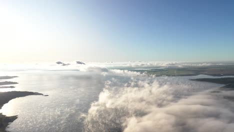 aerial view of clouds over hydroelectric power plant pond, fog at dawn