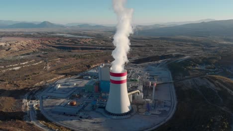 drone tracking steam from a coal fired power station plant sunset blue clear sky