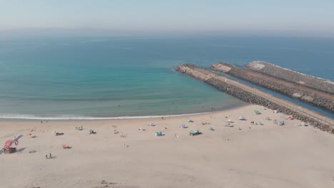 drone flies forward into an aerial view of the beach of sã£o torpes