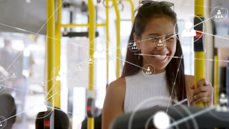 woman holding handrail and browsing smartphone on city bus, displaying technology network overlay