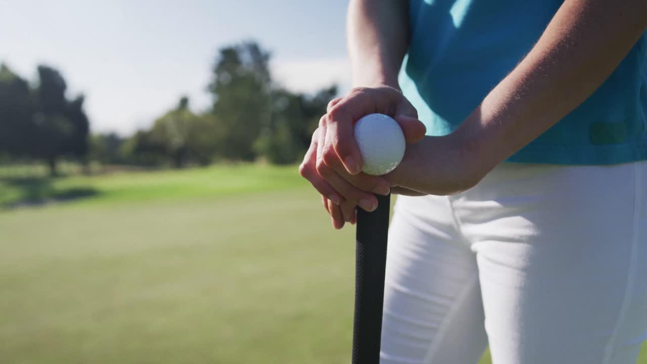 골프장 에 서 있는 공 과 골프 클럽 을 들고 있는 백인 여성 골프 선수