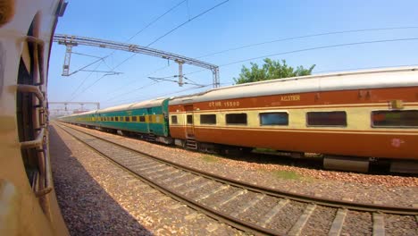 Train-window-leaning-out-point-of-view-during-long-distance-train-ride-travel,-Indian-Railways