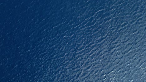 top down drone view of pulsing currents moving across ocean sea water surface