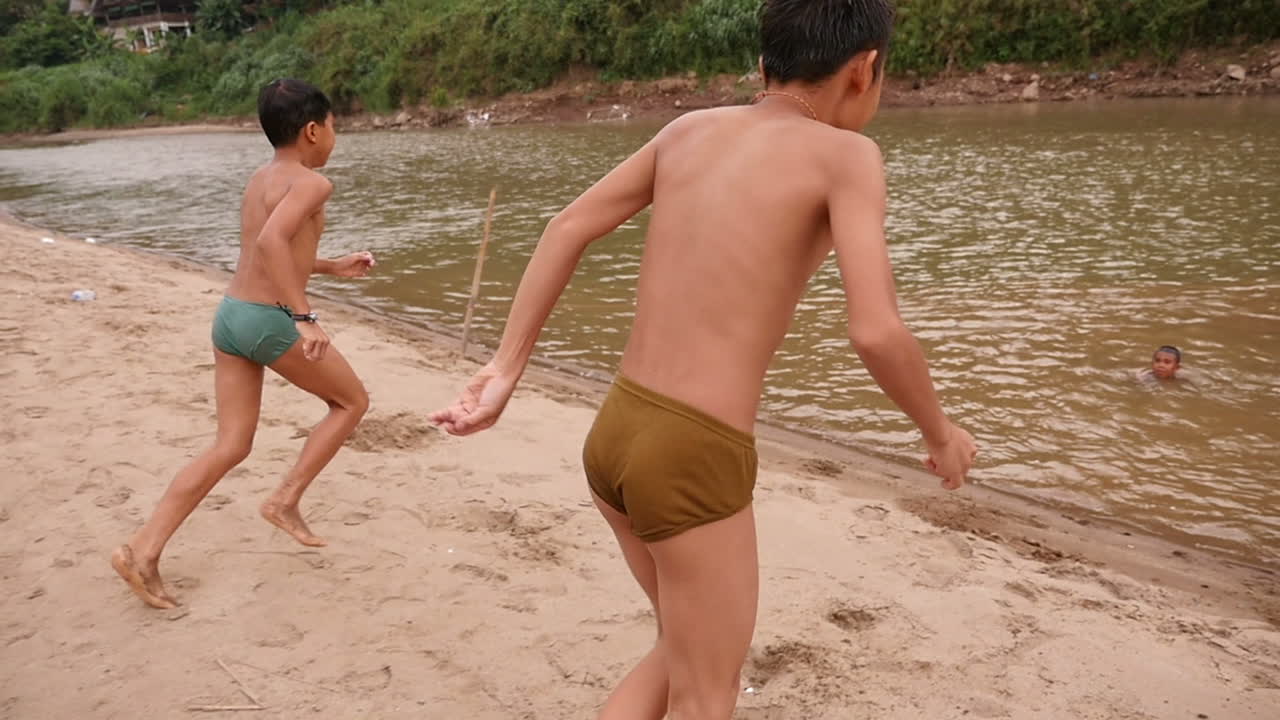 Children Swimming in a River