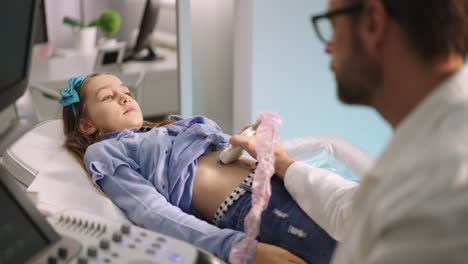 child undergoing an ultrasound examination with a doctor