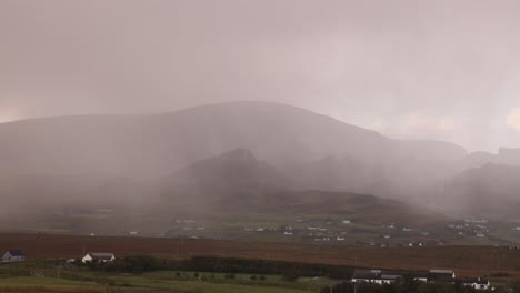 rain storm blowing through the mountains on isle of skye, highlands of scotland