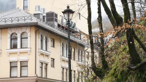 old european building with trees and mountains in autumn