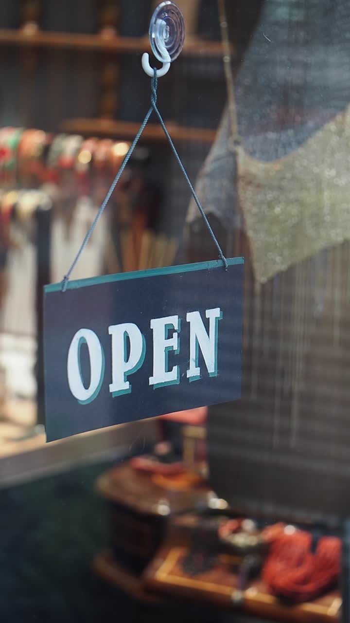 Open Sign Hanging in a Shop Window