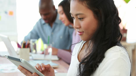 Casual-worker-using-tablet-pc-at-meeting