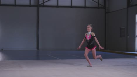 Teenage-female-gymnast-performing-at-sports-hall