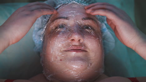 young plus-size woman with foil on face touches mask closeup