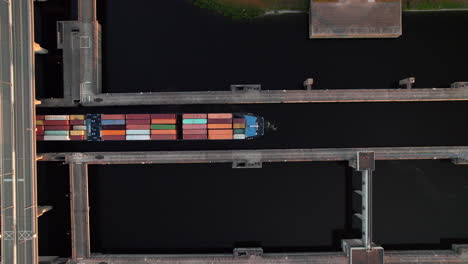 aerial view of a container ship passing through a lock