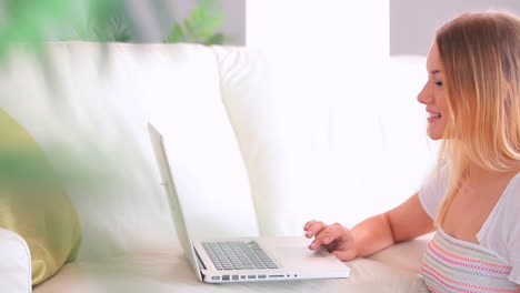 Concentrated-charming-blonde-using-her-laptop