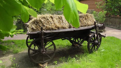 antique wooden hay cart in a garden setting