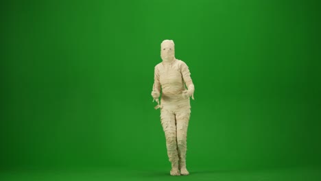 a mummy wrapped in bandages dancing waving hands and legs green screen isolated chroma key video - a mummy wrapped in bandages dancing, waving hands and legs. green screen isolated chroma key video. mock up, workspace, advertisement. full length. side view. halloween holidays