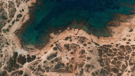 rocky beach on mediterranian sea with waves on rocks and turquoise water