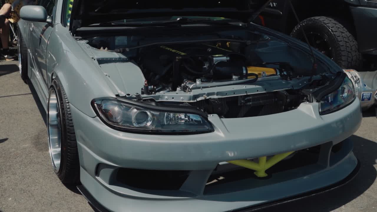 Gray Nissan 240SX with Hood Open at Drift Con Car Show.
