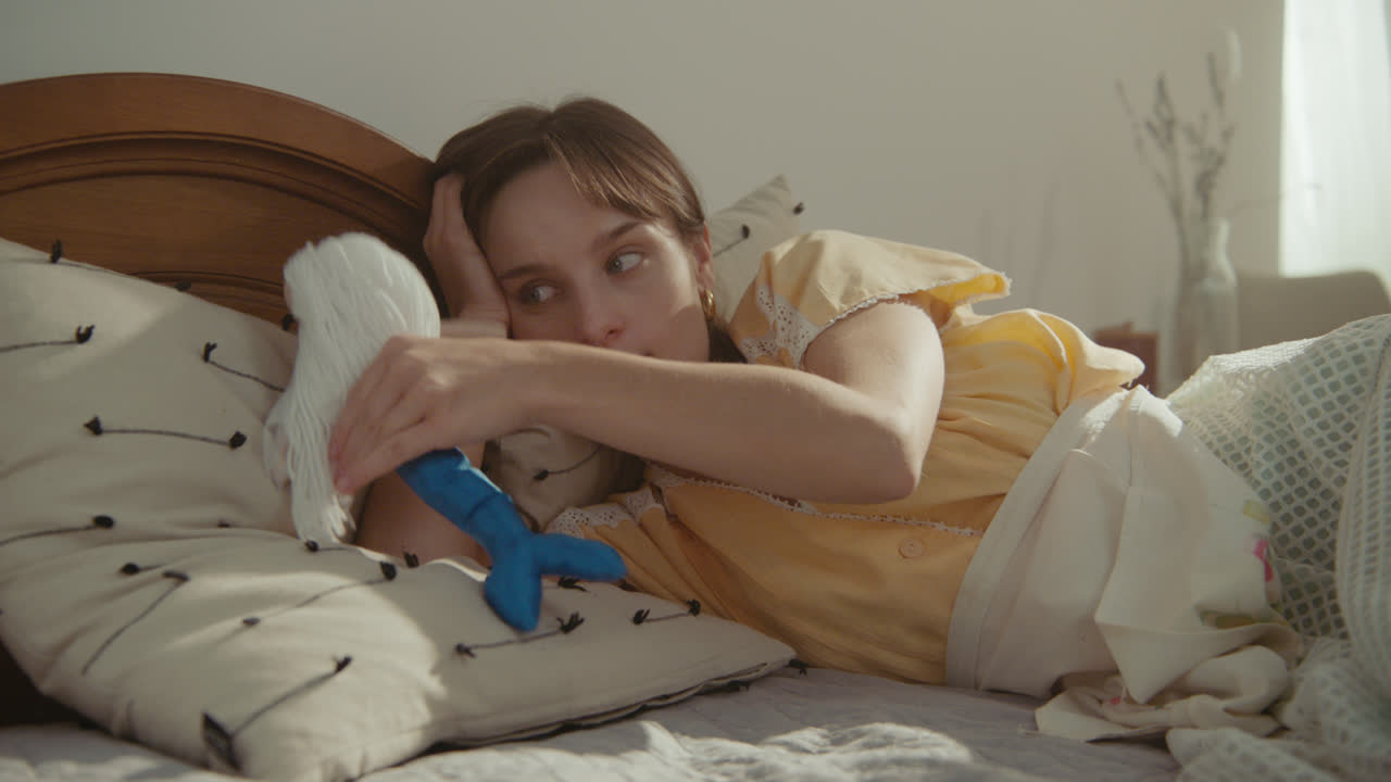 A girl playing with dolls in her room