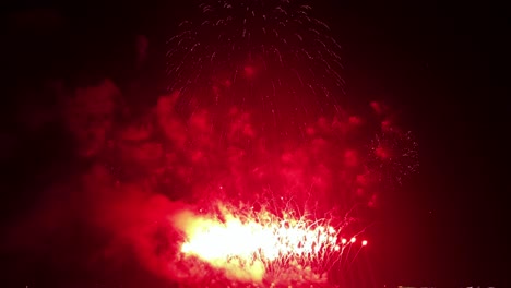 Multi-colored-pyrotechnics-bursting-in-a-rhythmic-fashion-and-filling-the-night-sky-with-bright-lights,-at-an-international-fireworks-festival-in-a-tourist-destination-in-Southeast-Asia