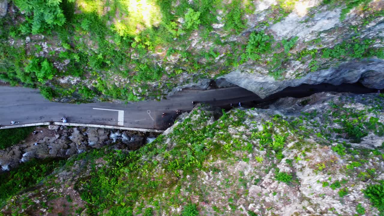 A dramatic top-down drone view of Strada della Forra, carved into the cliffs above Lake Garda—Italy’s most iconic mountain drive through rock and green.