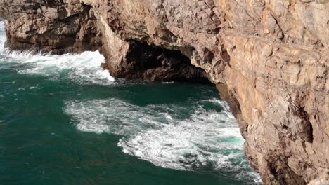 beautiful coastal rock formations and crashing sea waves under the sagres fortress in vila do bispo, algarve, portugal