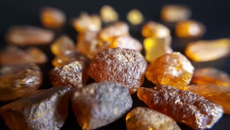 natural baltic amber stones on a black background-3