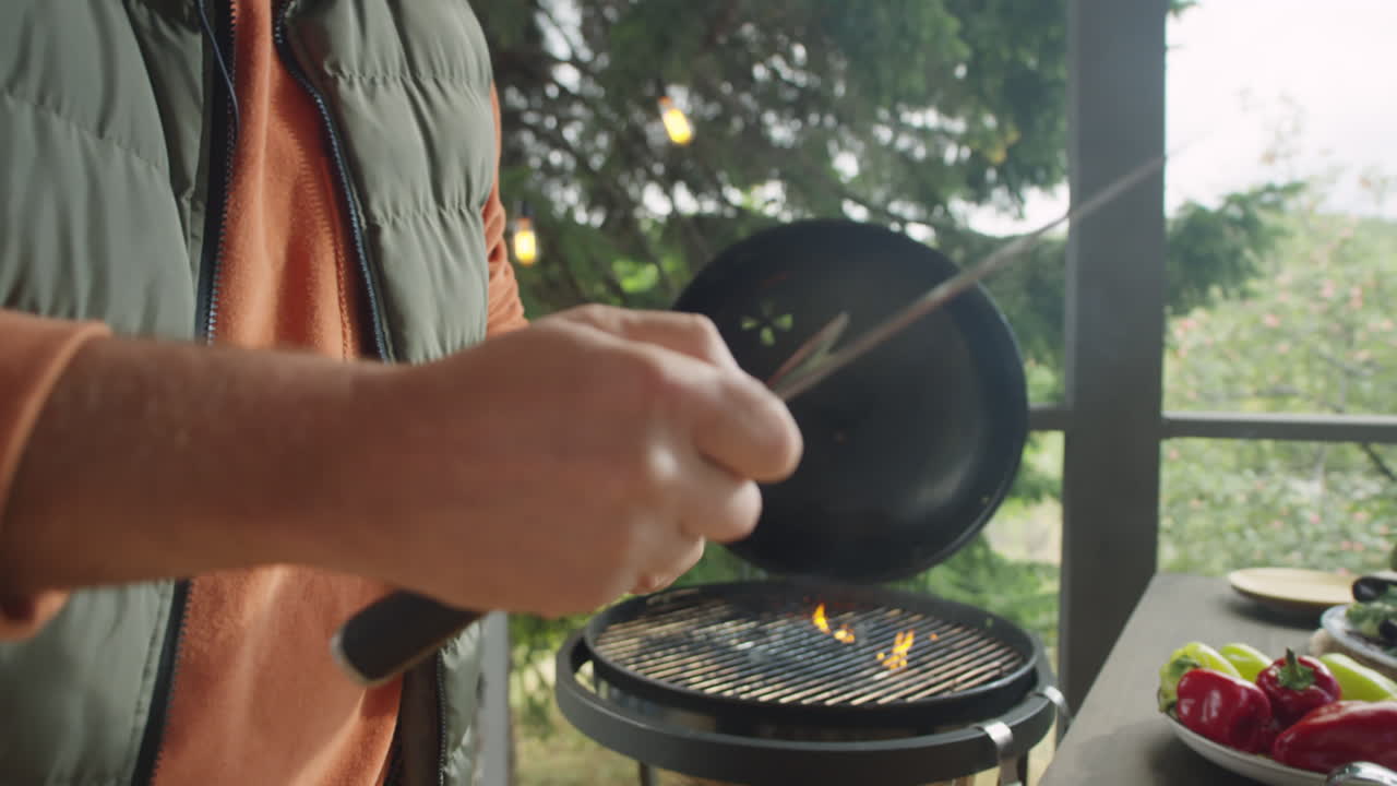 Hands of Chef Sharpening Knives on Outdoor Terrace